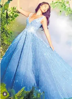  ??  ?? This dreamy blue gown shot with beads and silver thread reminded some of the gown actress Lily James wore as the lead in Disney’s 2015 live action film adaptation of Cinderella.