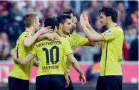  ?? AFP ?? Dortmund’s Marco Reus, Henrikh Mkhitaryan, Nuri Sahin and Mats Hummels celebrate a goal against Bayern Munich. —