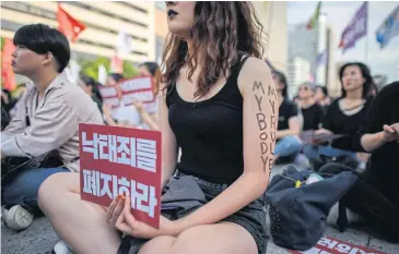  ?? ?? Protesters hold placards reading ‘Abolish punishment for abortion’ as they protest against South Korean abortion laws in Gwanghwamu­n plaza in Seoul in 2018.