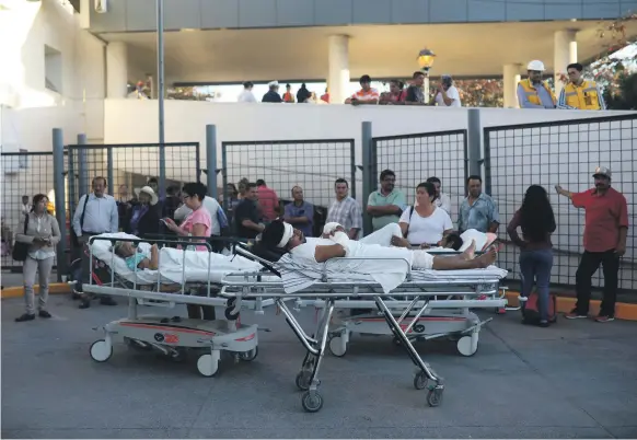  ?? AP ?? Patients rest in their hospital beds outside the general hospital from which they were removed in Veracruz, Mexico, on Friday after the earthquake