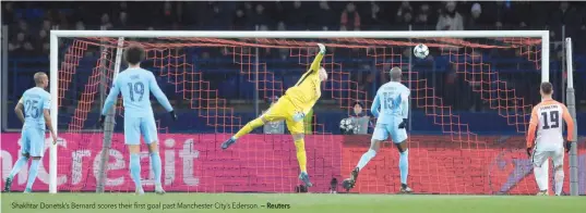  ?? — Reuters ?? Shakhtar Donetsk’s Bernard scores their first goal past Manchester City’s Ederson.