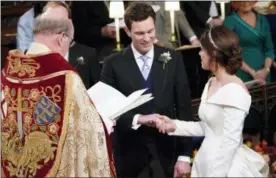  ?? DANNY LAWSON — POOL VIA AP ?? Britain’s Princess Eugenie and Jack Brooksbank during their wedding ceremony in St George’s Chapel, Windsor Castle, near London, England, Friday.