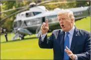  ?? ANDREW HARNIK / AP ?? President Trump speaks to reporters before boarding Marine One in Washington Wednesday. He called new informatio­n on the Russia dossier “a very sad commentary on politics in this country.”