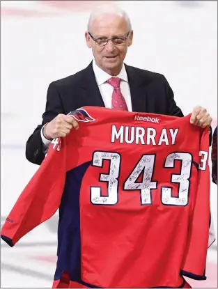  ?? CP PHOTO ?? Senior hockey advisor to the Ottawa Senators, Bryan Murray, holds a signed Washington Capitals jersey as he is inducted as the first member of the Ottawa Senators new Ring of Honour in Ottawa in January. The Ottawa Senators say former NHL coach and...