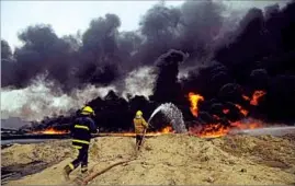  ??  ?? Iraqi crews battle a fire last month at an oil field in Qayara, 40 miles south of Mosul. AP