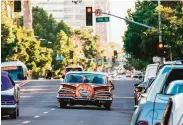  ?? Steven Martinez Jr. / South Bay Visions ?? Lowriders navigate San Jose streets. San Jose is looking to reverse a decades-old ban on cruising.