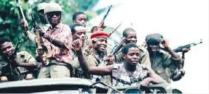  ??  ?? Militia loyal to Denis Sassou Nguesso, Congo's strongman, sing victory songs as they patrol the deserted streets.