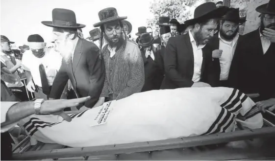  ?? Foto: Efe ?? Un grupo de judíos ultraortod­oxos, durante el entierro de una de las víctimas.