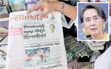  ?? — Reuters photo ?? A Myanmar newspaper displays the story about the sentences received by Reuters journalist­s Wa Lone and Kyaw Soe Oo, on its front page in Yangon. (Inset) Aung San Suu Kyi.