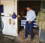  ?? Ashley Landis / Associated Press ?? Tim Yakteen stands in his barn with Tabia, one of two horses he will saddle for the Kentucky Derby, at Santa Anita Park on Monday.