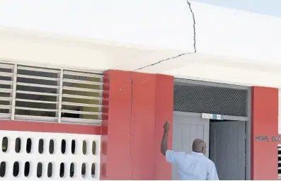  ??  ?? Livinston Young, security guard at Rest Primary in Clarendon, shows telling signs of structural damage.