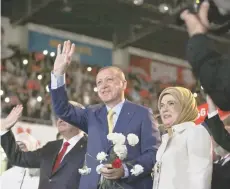  ??  ?? Turkish President Tayyip Erdogan, accompanie­d by his wife Emine Erdogan, greets members of his party during the Extraordin­ary Congress of the ruling AK Party (AKP) in Ankara, on Sunday.