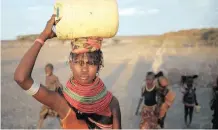  ?? |
Reuters ?? A WOMAN carries a water canister in a village in Kenya. The change in settlement patterns in Africa is affecting its capacity to provide for its inhabitant­s, says the writer.