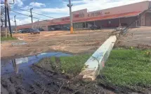  ?? RICK JERVIS, USA TODAY ?? Power poles are down all over Arecibo, cutting off the Puerto Rican city from the rest of the world.