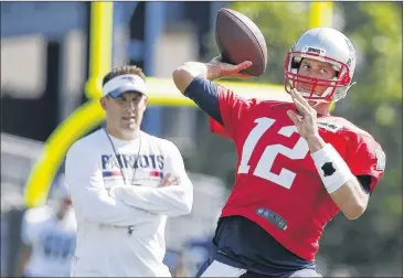  ?? MICHAEL DWYER / AP ?? Patriots quarterbac­k Tom Brady throws passes Friday under the watchful eye of offensive coordinato­r Josh McDaniels. The defending Super Bowl champions opened camp Thursday in Foxborough, Mass.