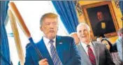  ?? REUTERS ?? Carrot & stick policy: Trump with Vice President Mike Pence