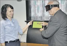  ?? ASHley tHomPSoN/tc media ?? Acadia University researcher Dr. Anne Sophie Champod shows Health Minister Leo Glavine the app she’s developing as a potential home-based treatment program for the spatial neglect condition that commonly presents in stroke survivors. The app is...
