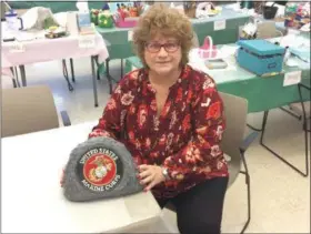  ?? CHAD FELTON — THE NEWS-HERALD ?? Wendy Butler with her “rock” at the Willowick Senior Center on Nov. 9. The Eastlake resident painted the concrete piece to honor her son-in-law, Sgt. Joe Blum, who is stationed in Okinawa, and plans to give it to him when he returns home in 2020.