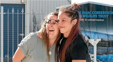  ?? HELEN NICKISSON/STUFF ?? Sarah Wikotu (right) embraces her friend Kerrie Dick when the surprise podium party is revealed. Dick organised a ‘‘podium finish’’ for Wikotu after a scoring error put her in second place at the Fittest Mum Competitio­n and denied her the podium in Auckland.