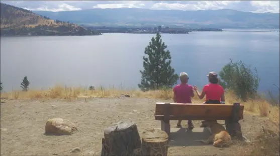  ?? J.P. SQUIRE/Special to The Okanagan Weekend ?? The reward for climbing a steep hill on the Canyon Rim Trail at Bear Creek Provincial Park is a bench with a panoramic view of Okanagan Lake and Kelowna. Then, it’s back to the 2.5-kilometre trail, which has numerous lookouts so you can look down at...