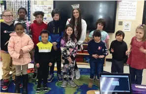  ?? Submitted photo ?? USA National Miss Arkansas Junior Teen 2023 April Flores is shown with students at Oaklawn STEM Magnet School on Feb. 3 after reading to them during the Trojans Love Reading event.