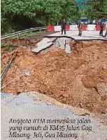  ?? ?? Anggota ATM memeriksa jalan yang runtuh di KM35 Jalan Gua Musang-jeli, Gua Musang.