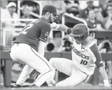  ?? CRAVEN WHITLOW/ Nate Allen Sports Service ?? LEFT: Arkansas freshman Matt Goodheart slides into third in a 1-0 loss to Florida State Saturday in Omaha, Nebraska.