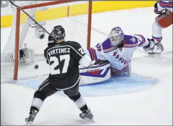  ?? Mark J. Terrill The Associated Press ?? Defenseman Alec Martinez, then with the Kings, scores the 2014 Stanley Cup-clinching goal past Rangers netminder Henrik Lundqvist in the second overtime period.