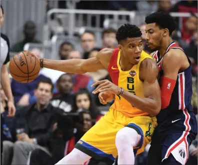  ?? File photo ?? Giannis Antetokoun­mpo and the first-place Milwaukee Bucks may get the chance to compete for the NBA title if the players and the NBA can agree to play games at a hub, likely the Disney campus near Orlando.