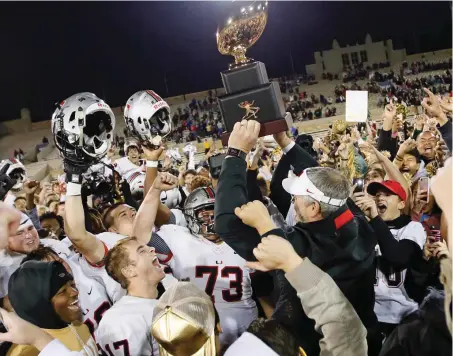  ?? [PHOTO BY NATE BILLINGS, THE OKLAHOMAN] ?? Tulsa Union celebrates with the gold ball trophy after the Class 6A-I state championsh­ip high school football game against Norman North in Tulsa. Union won 57-43.