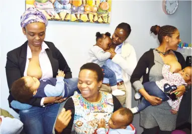  ??  ?? Limpopo Health MEC Dr Phophi Ramathuba (seated) flanked by breastfeed­ing mothers who came to the launch.