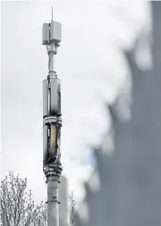  ??  ?? A fire-damaged telecom tower, reported in local media as being a 5G network mast on the EE network, operated by BT Group Plc, stands in Birmingham on Monday.