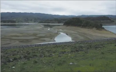  ?? PHOTOS BY KAREN RIFKIN ?? Looking esst from Coyote Dsm st Lske Mendocino, towsrd the little islsnd where the geese live. As of the first week in Msrch, the reservoir wss st only 46 percent of its tsrget wster supply curve—sbout 33,000 scre-feet of its totsl cspscity of sbout 118,000 scre-feet.