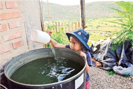  ?? MARTIN NUMBELA ?? Una niña saca agua de un turril que fue comprada de un carro cisterna.