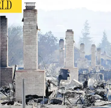  ?? JOSH EDELSON / AFP / GETTY IMAGES ?? Chimneys are all that remain standing amid a swath of burnt-out properties in Santa Rosa, Calif., Thursday. At least 29 people are dead and hundreds remain missing after wildfires swept through Northern California.