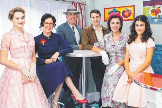  ?? ?? Annabel Crabb (second from left) with the Ferrones family from Back In Time for the Corner Shop; and (below), Crabb out the front of the store.