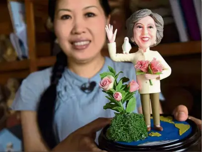  ??  ?? May-de in China Artist Wu Xiaoli showing a clay figure featuring British Prime Minister Theresa May at her shop to mark the upcoming G20 summit in Hangzhou in Zhejiang province. China will host the G20 summit in Hangzhou from sept 4 to 5. — AP
