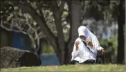  ?? NURHASANAH / AP ?? A woman prays at a mass grave for the victims of Indian Ocean tsunami, during the commemorat­ion of the 15th anniversar­y of the disaster in Banda Aceh, Indonesia, Thursday. Over 200,000 lost their lives.