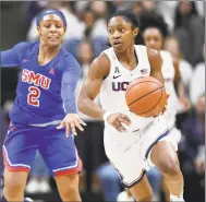  ?? Jessica Hill / Associated Press ?? UConn’s Crystal Dangerfiel­d, right, pulls away from SMU’s Ariana Whitfield on Thursday in Storrs.