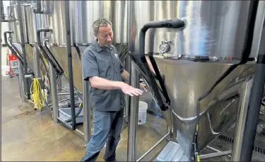  ?? Loveland Reporter-herald file photo ?? Josh Grenz, head brewer and co-owner of Verboten Brewing Co., shown here in 2018 in his downtown Loveland brewery, was one of the brewery owners and leaders who shared their views last week about surviving a pandemic winter and beyond.