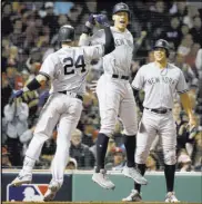  ?? Elise Amendola The Associated Press ?? Yankees catcher Gary Sanchez, left, celebrates after his three-run home run with Aaron Judge, center, and Giancarlo Stanton during the seventh inning Saturday.