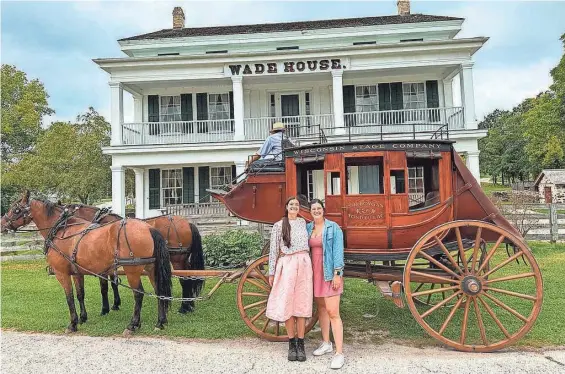  ?? PHOTOS/JULIA SILVERS ?? Sisters Haley Dolata, left, and Julia Silvers pose in front of a stagecoach at Wade House in Greenbush during a Wisconsin history road trip.