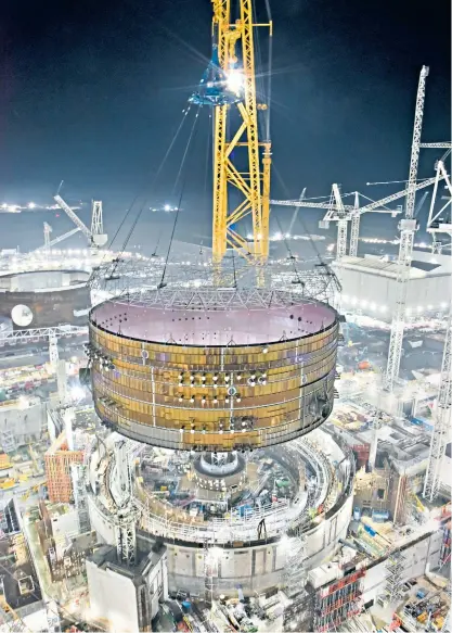  ?? ?? Big Carl, the world’s biggest crane, places a steel ring on a reactor at Hinkley Point C in Somerset. China General Nuclear, which is building the plant with France’s EDF, faces opposition to its involvemen­t in Sizewell C in Suffolk