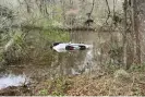  ?? ?? A submerged car in Georgia’s Brier Creek, where a woman and her two children were rescued by five members of a sorority. Photograph: Sardis Police Department