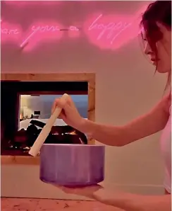  ??  ?? (above) Recently, Kendall Jenner shared a video of herself sitting on the floor in a dimly lit room conducting a DIY sound bath, an ancient healing practice that uses sound therapy to promote healing and relaxation. In the clip, Jenner runs a mallet counter-clockwise along the rim of a crystal singing bowl