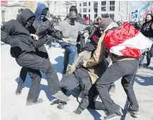  ??  ?? Opposing groups of protesters clash during a demonstrat­ion over motion M-103 in Montreal on Saturday.