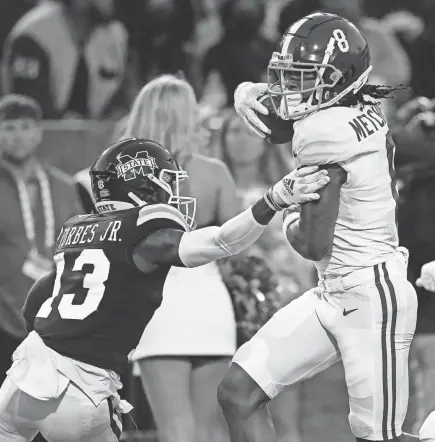  ?? ROGELIO V. SOLIS/AP ?? Alabama wide receiver John Metchie III (8) fights off a tackle attempt by Mississipp­i State cornerback Emmanuel Forbes (13) on his way to a 46-yard touchdown pass reception last Saturday.