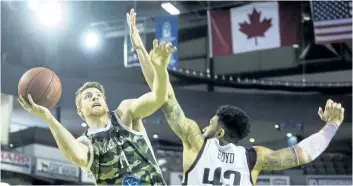  ?? JULIE JOCSAK/ STANDARD STAFF ?? Connor Wood of the Niagara River Lions shoots the ball past Julian Boyd of the London Lightning in basketball action at Meridian Centre in St. Catharines on Sunday.