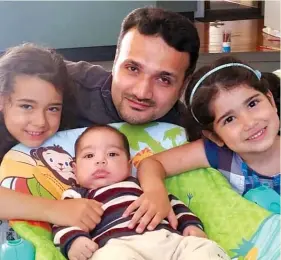  ??  ?? Osama Abu Kwaik with his three children in New Zealand.