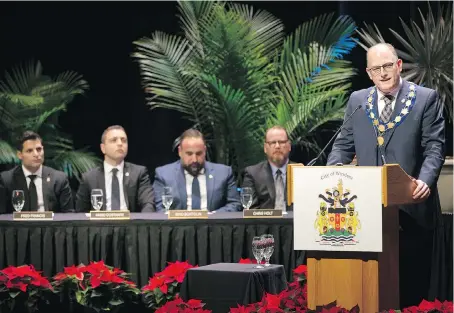  ?? DAX MELMER ?? Mayor Drew Dilkens makes an opening speech at the inaugural meeting of the new city council at St. Clair Centre for the Arts Monday as, from left, councillor­s Fred Francis, Fabio Costante, Rino Bortolin and Chris Holt look on. The auto industry’s future was a key focus of Dilkens’ address.